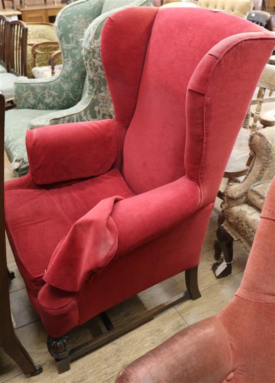 A Georgian style upholstered wing armchair